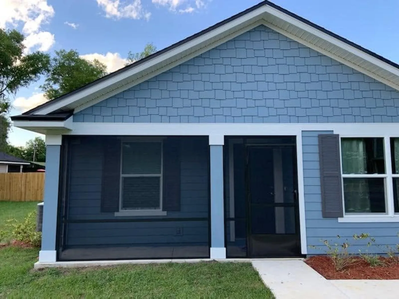 Screened front porch on a blue Northeast Florida home