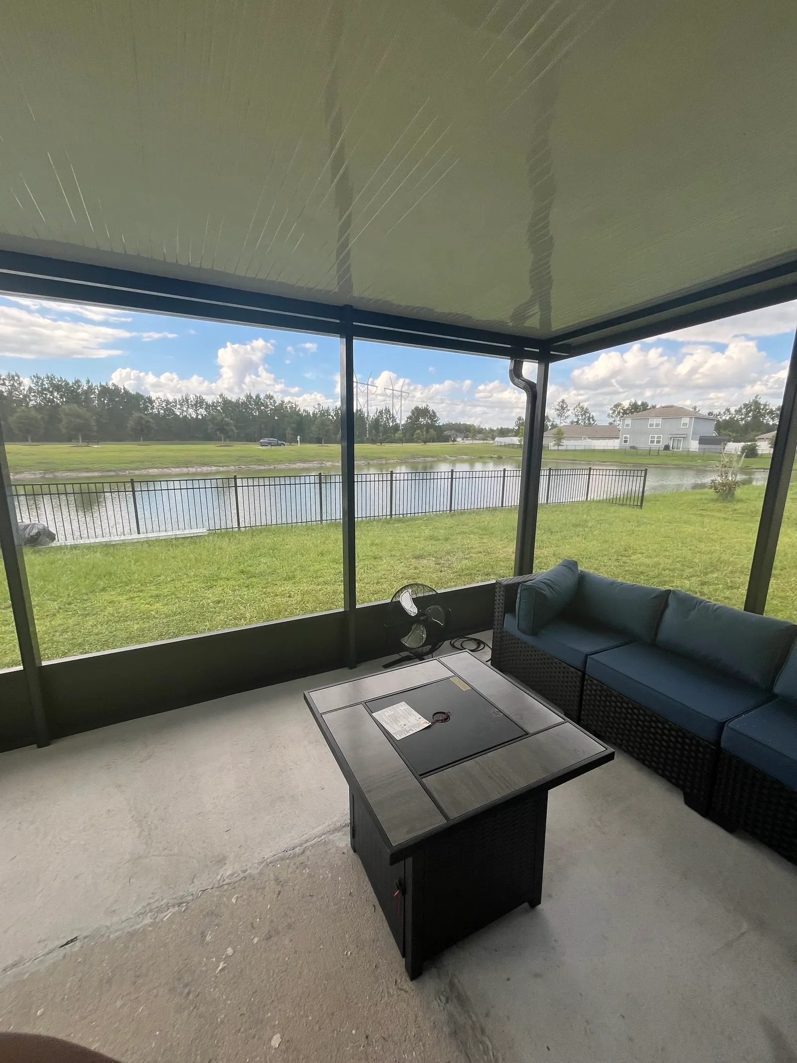 Inside a finished screen room looking out over a pond, with insulated roof panels, in Greater Jacksonville, FL